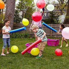 children hitting balloons with pool foam